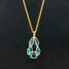 Diamond Tear Drop Cage Necklace with Blue Topaz Insert